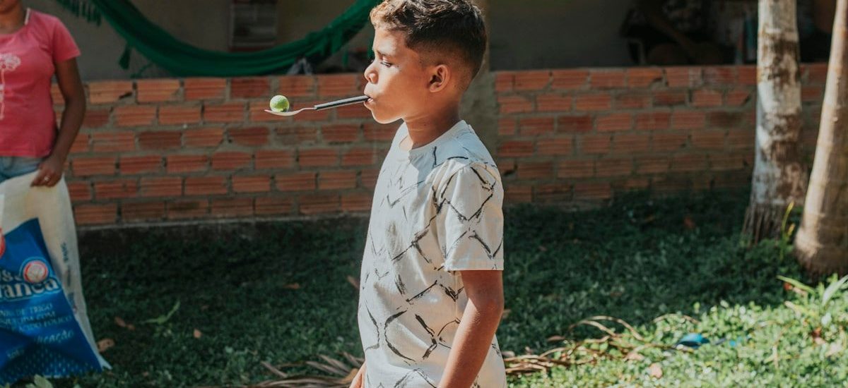 boy in white and black button up shirt playing bubbles