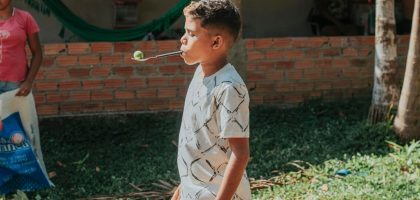 boy in white and black button up shirt playing bubbles