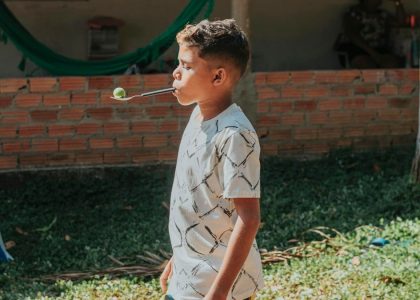 boy in white and black button up shirt playing bubbles